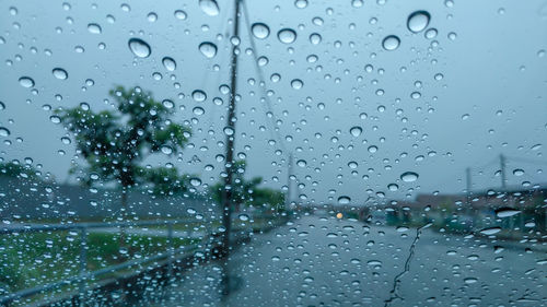 Full frame shot of wet glass window during rainy season