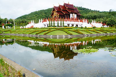 Scenic view of lake by building against sky