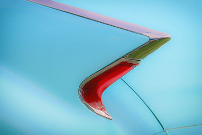 Close-up of red flag against blue background