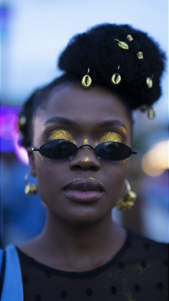 headshot, portrait, front view, one person, lifestyles, young adult, focus on foreground, real people, leisure activity, close-up, sunglasses, glasses, fashion, young women, looking at camera, outdoors, day, human body part, hairstyle, human face