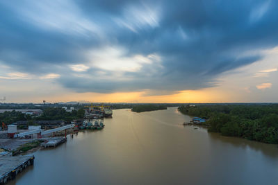 High angle view of river amidst buildings against sky