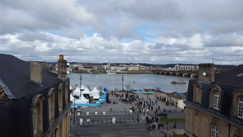 View of town by sea against sky