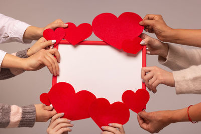 Midsection of couple holding heart shape