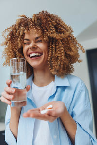 Portrait of young woman drinking glass