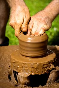Close-up of hands working in mud