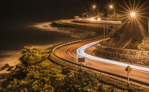 High angle view of light trails on road at night