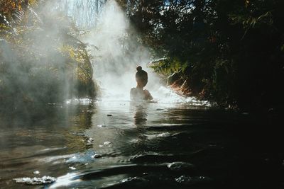 Woman swimming in river