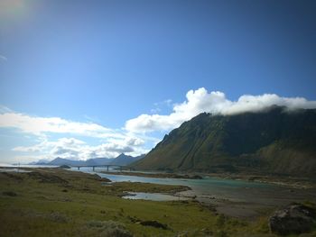 Scenic view of mountains against cloudy sky