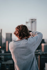Rear view of woman standing against sky