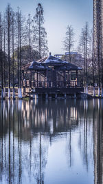 Reflection of building on lake against sky