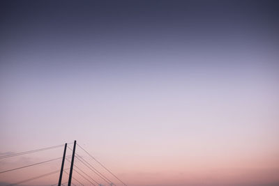 Low angle view of cables against clear sky