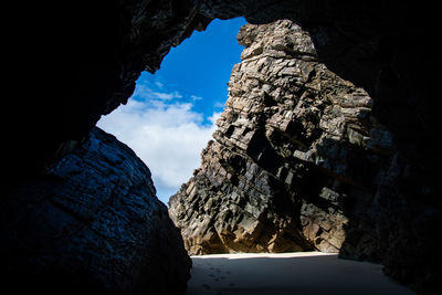 Low angle view of rock formation against sky