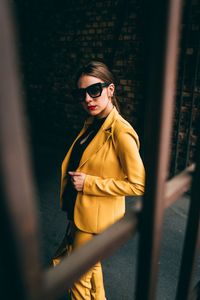 Young woman wearing sunglasses standing outdoors