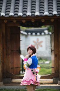 Full length of woman standing outside temple