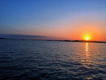 Scenic view of sea against clear sky during sunset