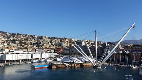 View of harbor against clear blue sky