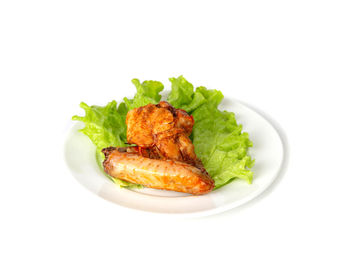 Close-up of salad in plate against white background