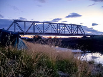 View of bridge over field against sky