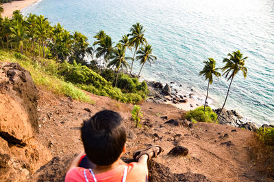 Rear view of boy on beach