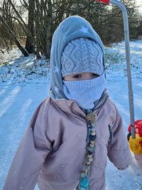 Portrait of woman with snow covered tree