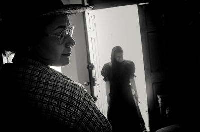 Young woman standing in corridor