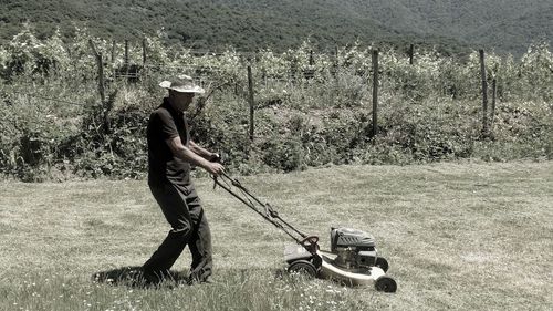 Full length of man mowing at lawn