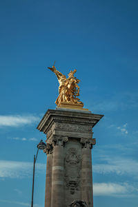 Low angle view of statue of liberty against sky