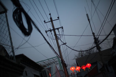 Low angle view of power lines against sky