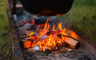 Fire pit with cauldron - cooking on the beach, close-up of fire