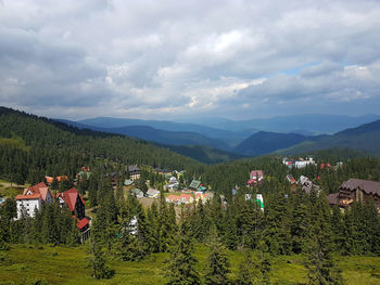 Scenic view of houses and mountains against sky