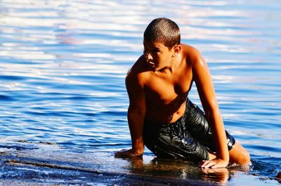 Full length of shirtless man in swimming pool