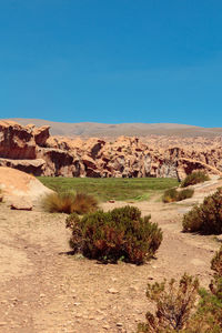 Scenic view of desert against blue sky