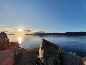 Scenic view of sea against clear sky at sunset