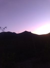 Silhouette mountain against clear sky during sunset