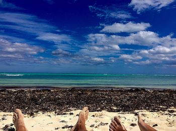Low section of beach against blue sky