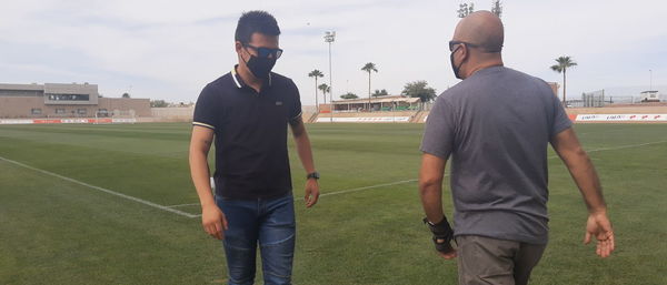 Full length of young man standing on grassland