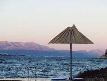 Scenic view of beach umbrella on shore