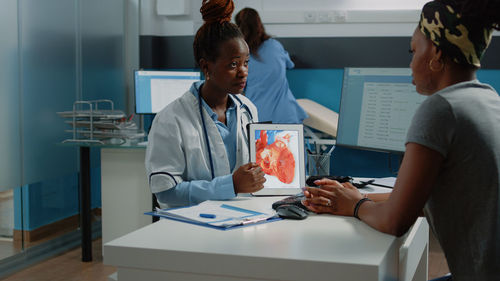 Doctor examining patient in office