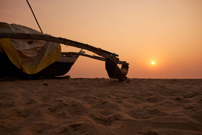 Man on beach against sky during sunset