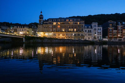 Reflection of illuminated buildings in lake at night