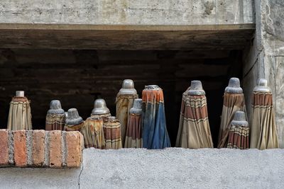 Row of bottles on wall in building