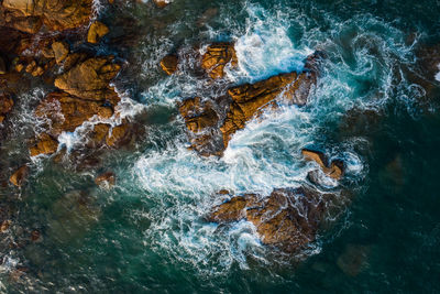 High angle view of rocks in sea