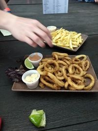 Close-up of hand holding food on table