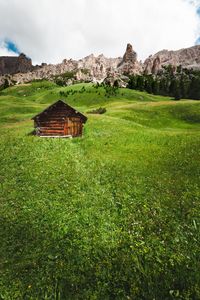 View of hut on landscape against sky