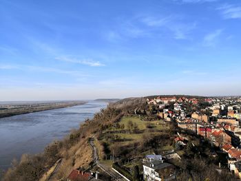 High angle view of townscape by sea against sky