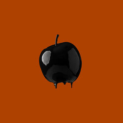 Close-up of electric lamp against orange background