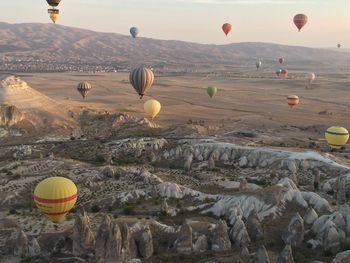 Hot air balloons flying over rocks