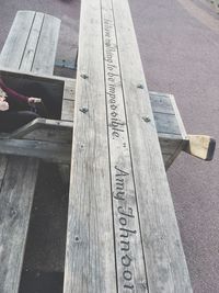 Low section of person on wooden bench