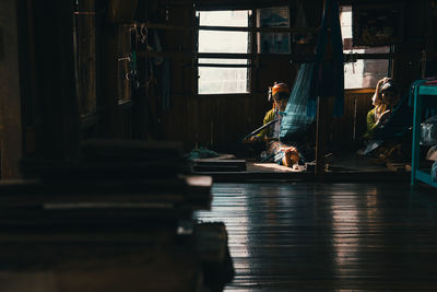 Women working on loom at home