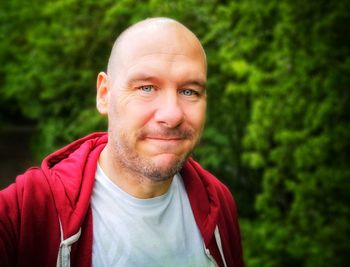 Portrait of smiling man against plants